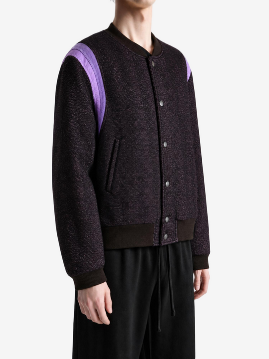 Purple jacket worn by a person, showing the jacket fit