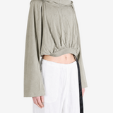 Green top worn by a person, showing the top fit