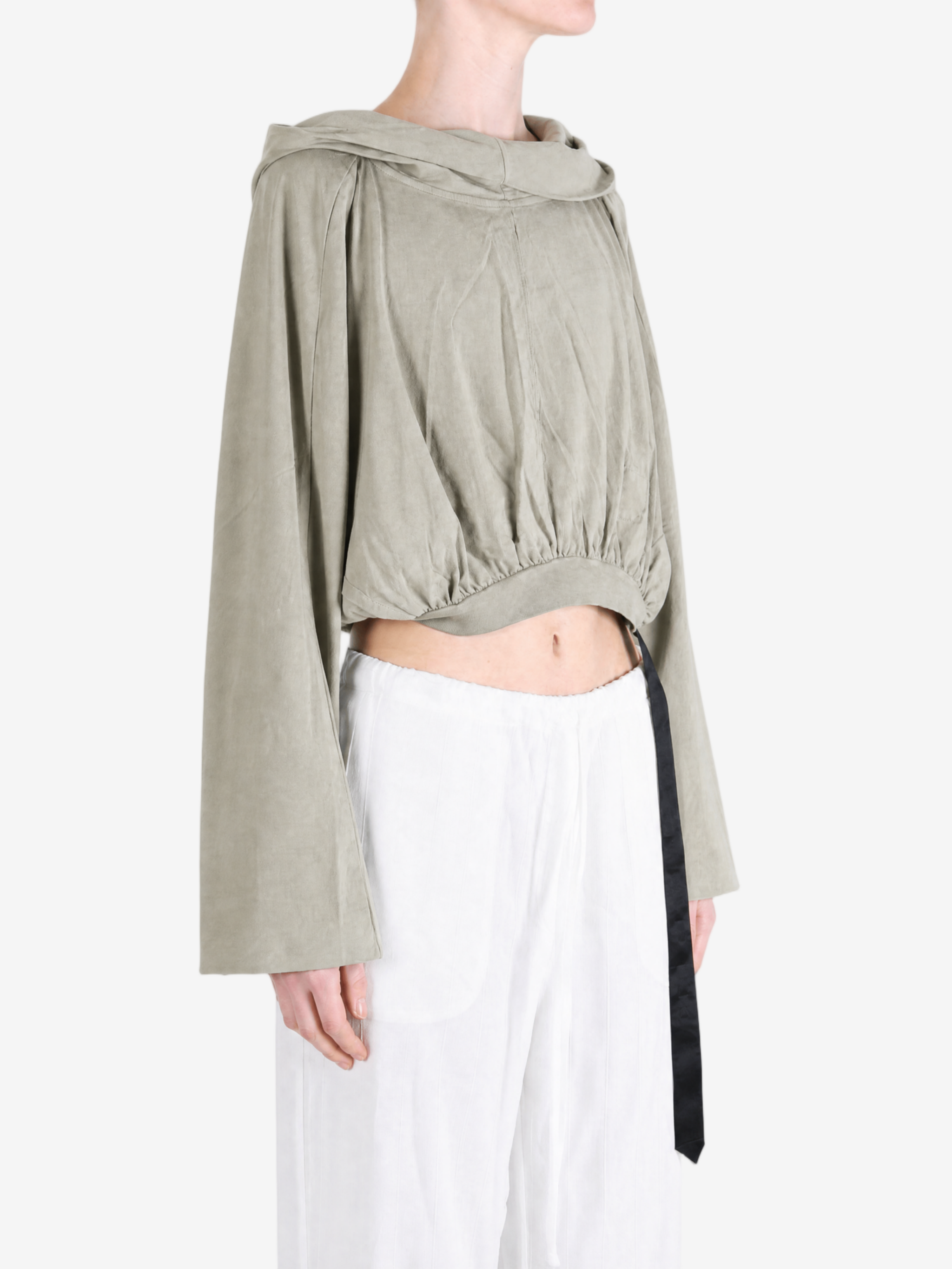 Green top worn by a person, showing the top fit