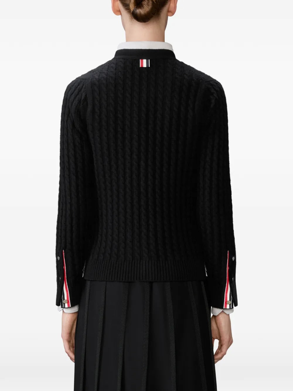 Black cardigan worn by a person, showing the cardigan's  fit