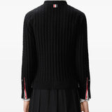 Black cardigan worn by a person, showing the cardigan's  fit