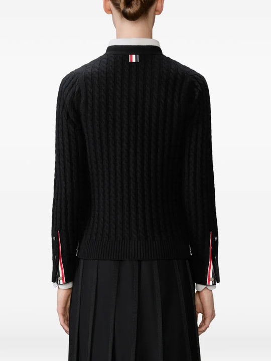 Black cardigan worn by a person, showing the cardigan's  fit