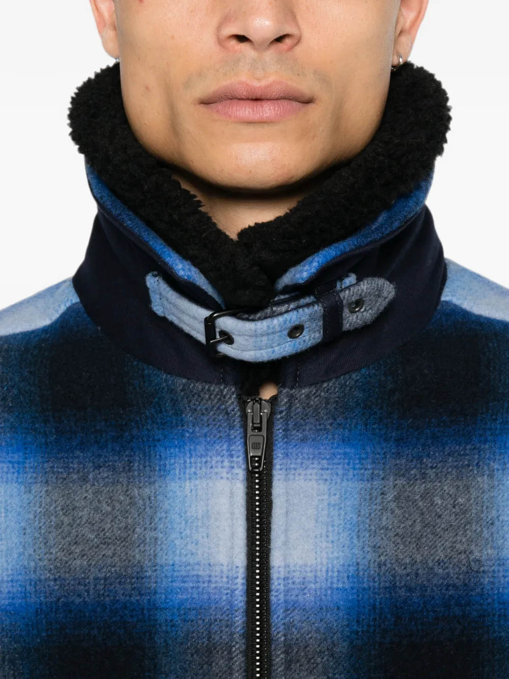 Blue jacket worn by a person, showing the jacket fit