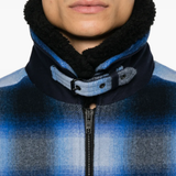Blue jacket worn by a person, showing the jacket fit