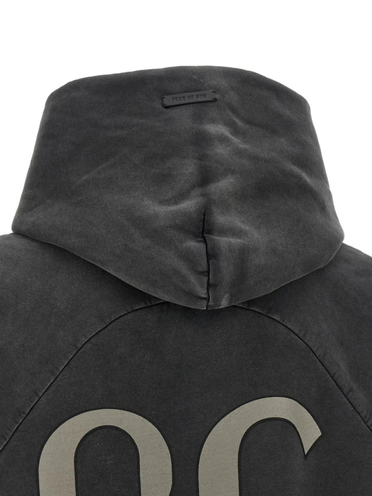 Black hoodie worn by a person, showing the hoodie fit