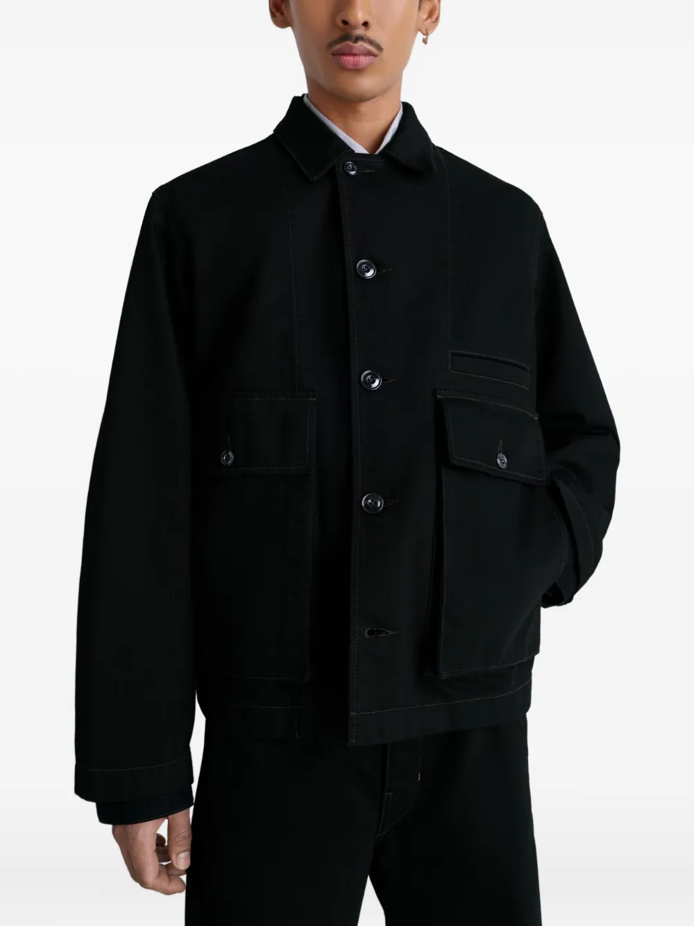 Black jacket worn by a person, showing the jacket fit