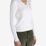 White knitwear worn by a person, showing the knitwear's fit
