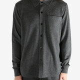 Grey shirt worn by a person, showing the shirt's fit