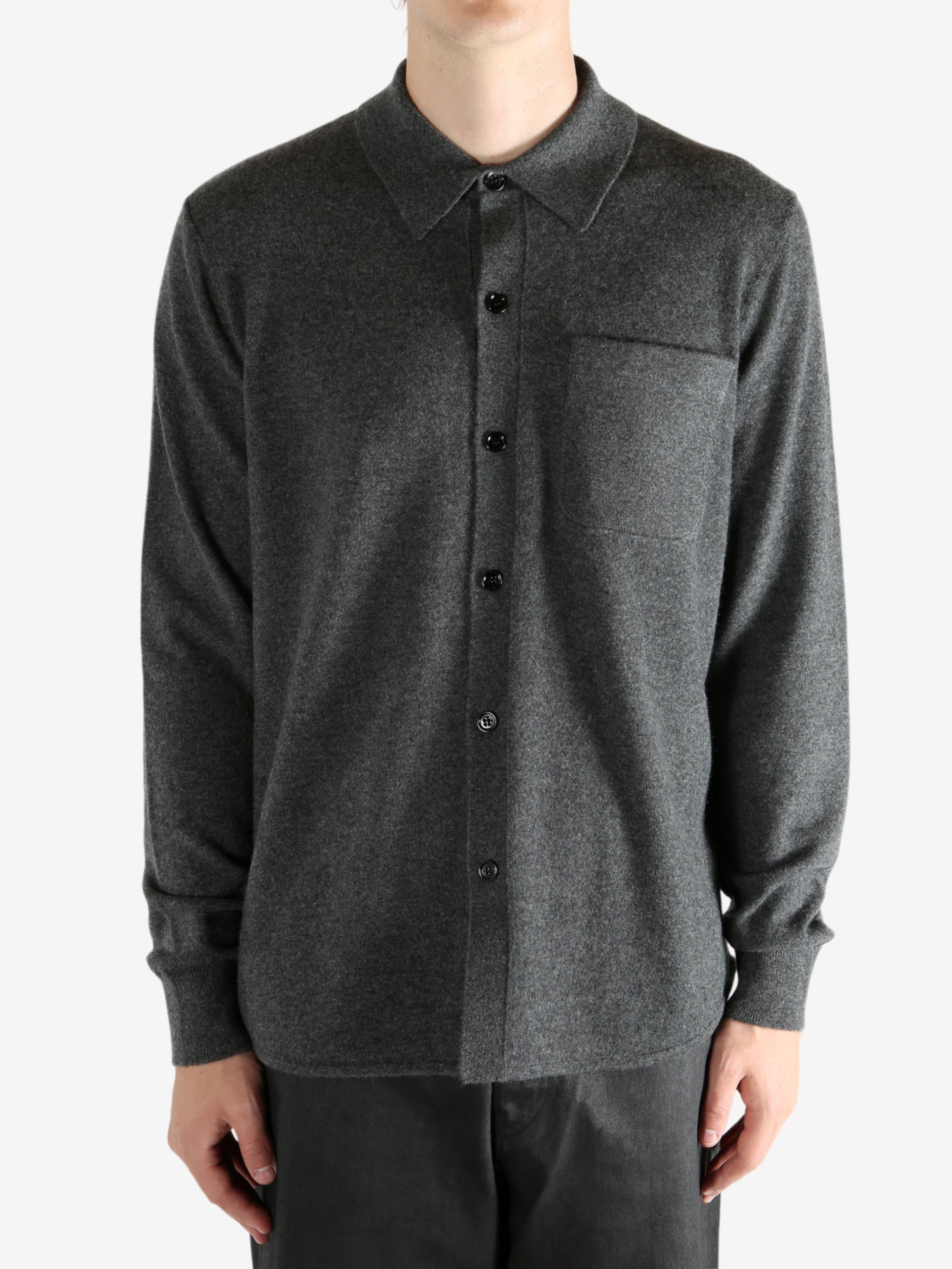 Grey shirt worn by a person, showing the shirt's fit