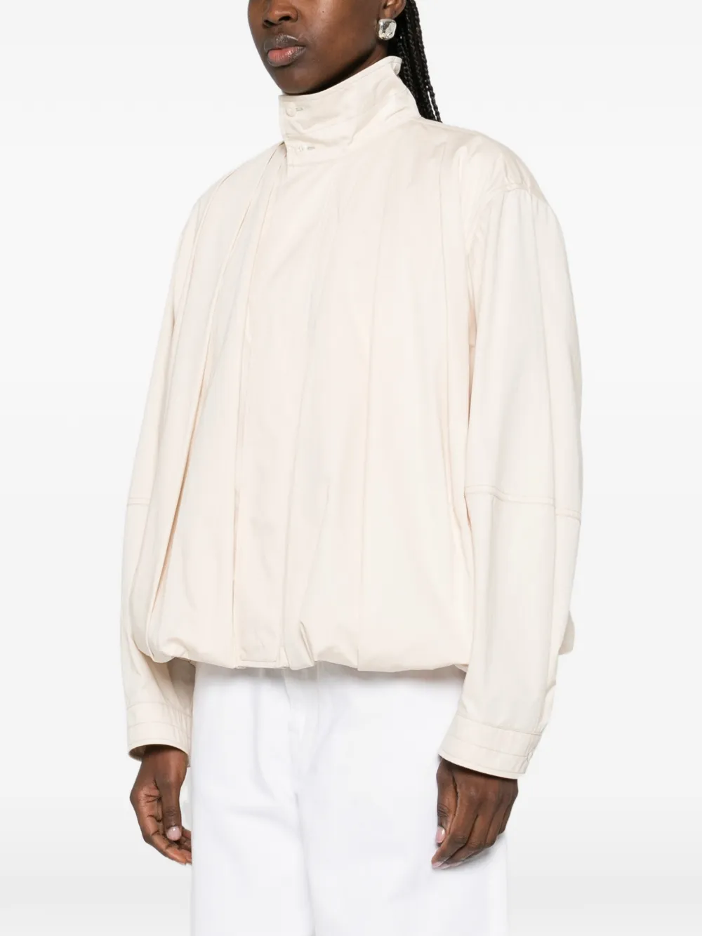 White jackets-coats worn by a person, showing the jackets-coats's fit