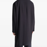 Black coats worn by a person, showing the coats fit