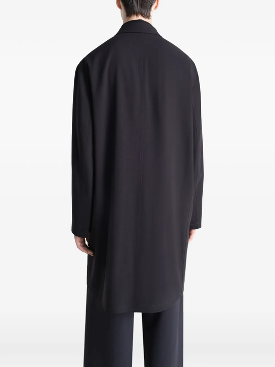 Black coats worn by a person, showing the coats fit