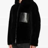 Black jacket worn by a person, showing the jacket's fit