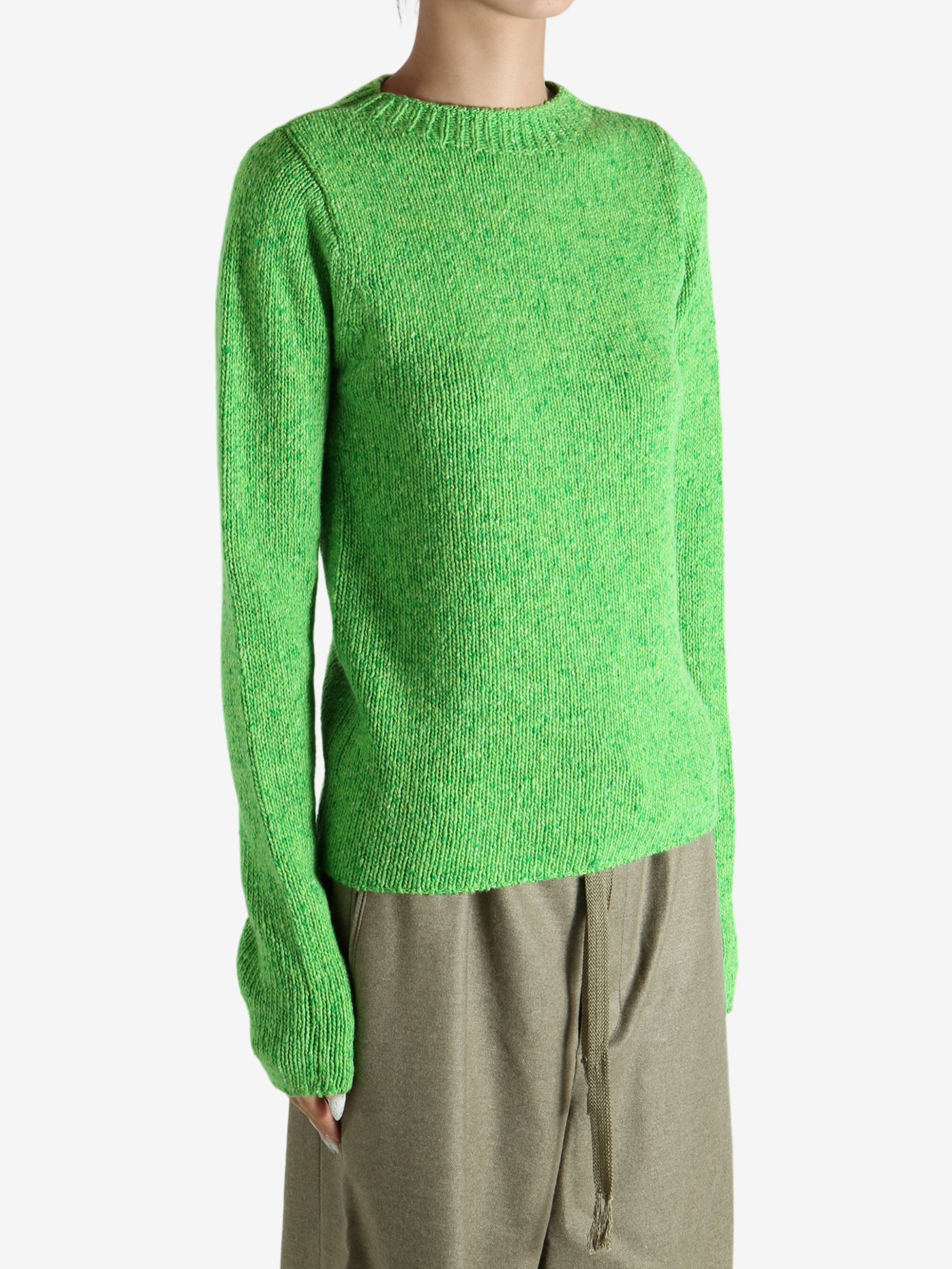 Green knitwear worn by a person, showing the knitwear fit
