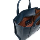 Close up of navy bags, showing texture of the leather fabric