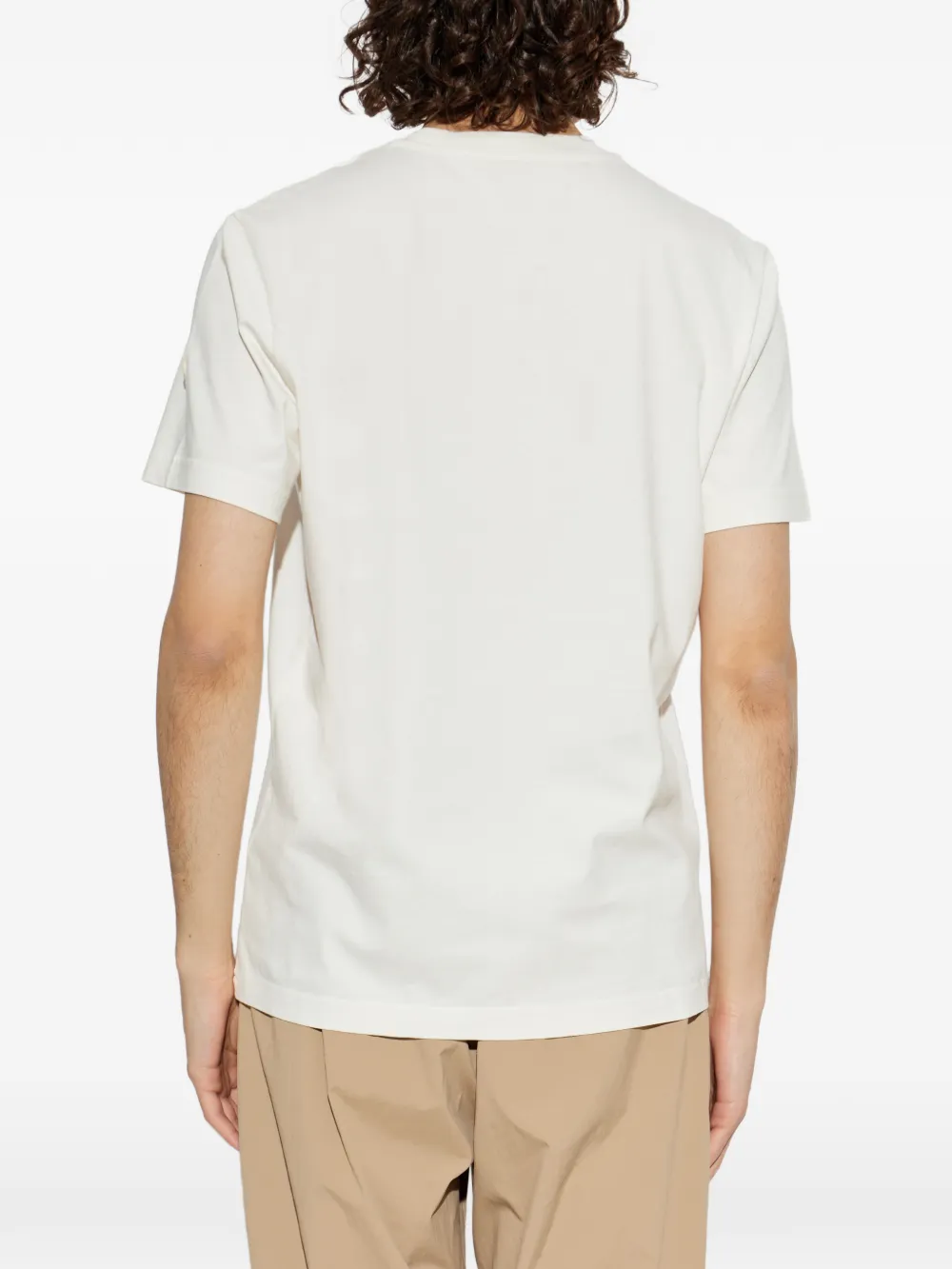 White t-shirt worn by a person, showing the t-shirt's fit