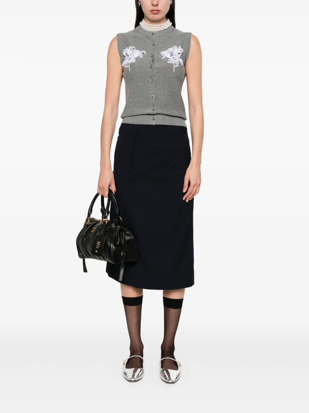 Grey cardigan worn by a person, showing the cardigan's fit