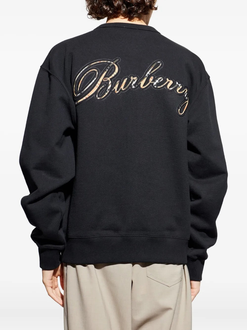 Black sweats worn by a person, showing the sweats' fit