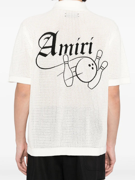 White knitwear worn by a person, showing the knitwear fit