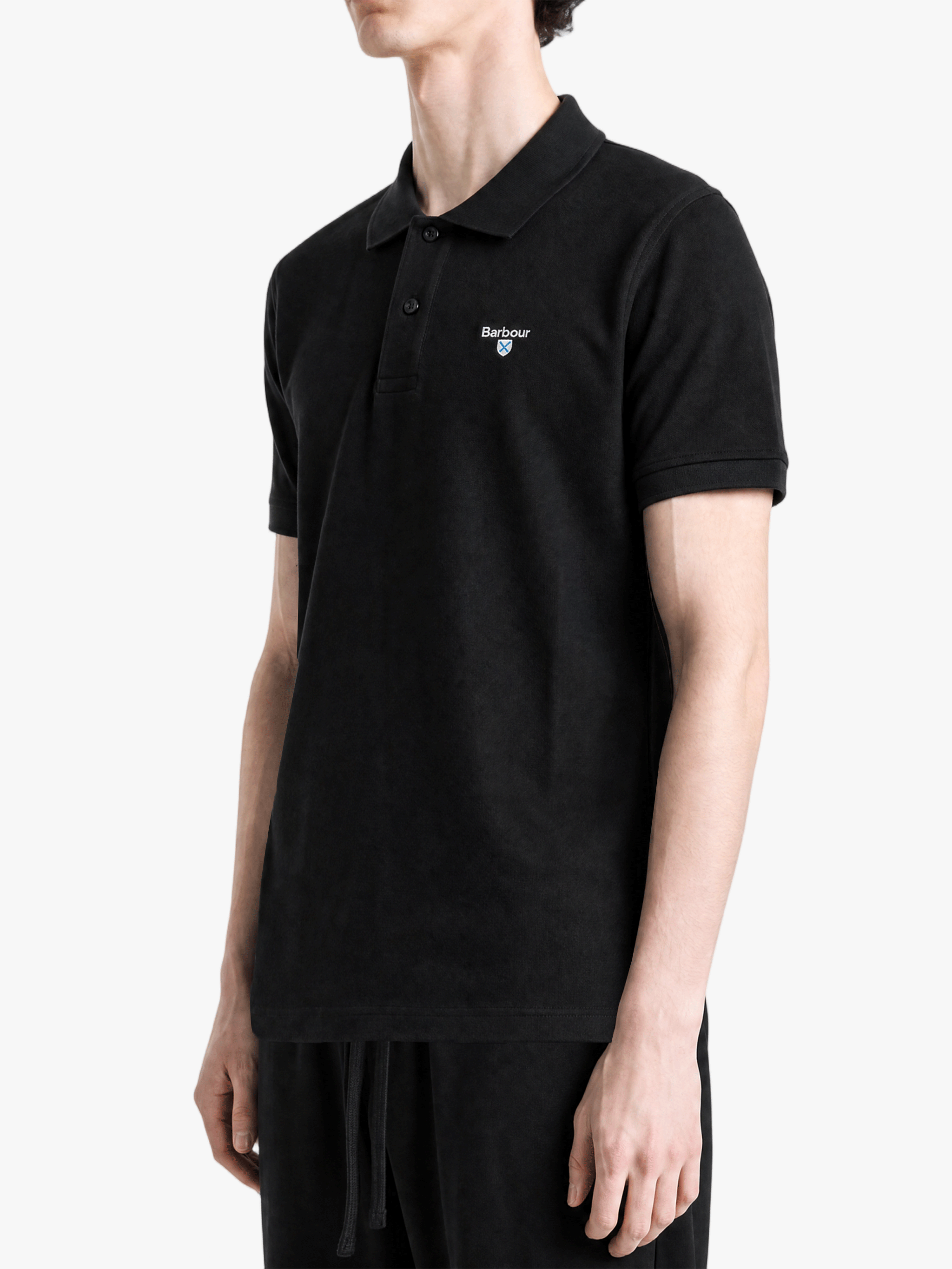 Black top worn by a person, showing the top fit