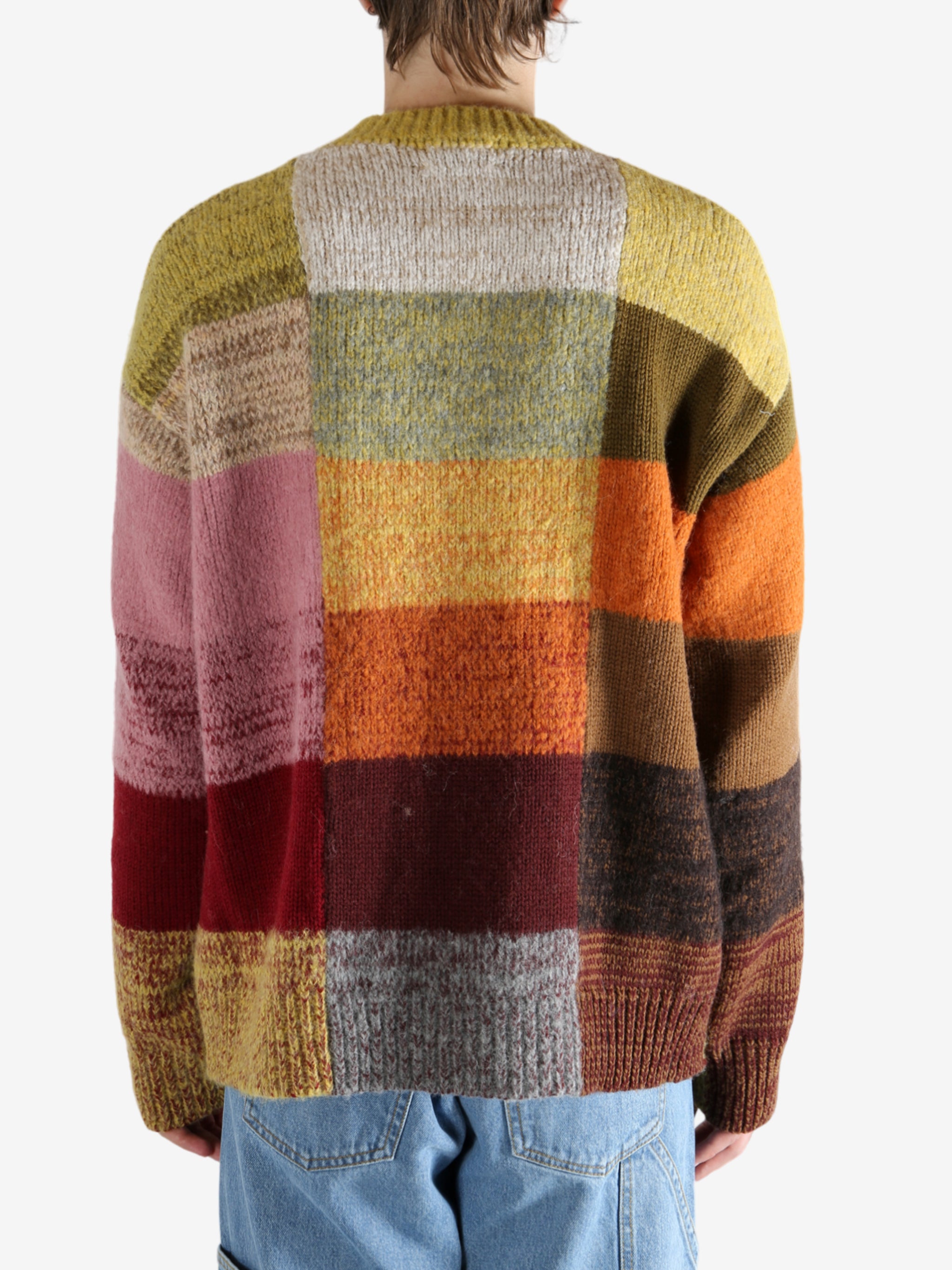 Yellow sweater worn by a person, showing the sweater's fit