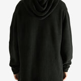 Black hoodie worn by a person, showing the hoodie's fit