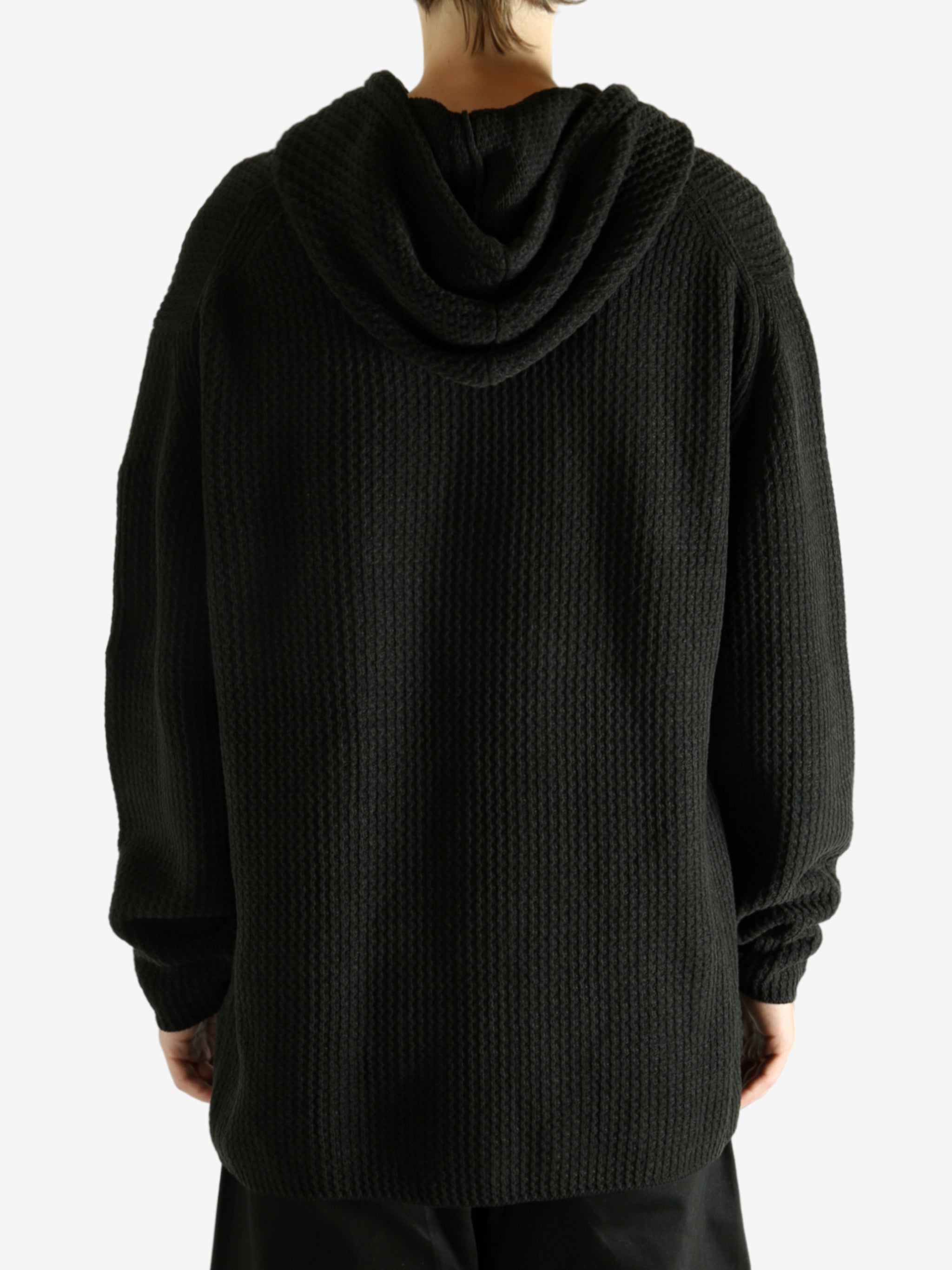 Black hoodie worn by a person, showing the hoodie's fit