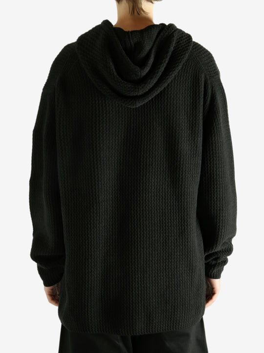 Black hoodie worn by a person, showing the hoodie's fit