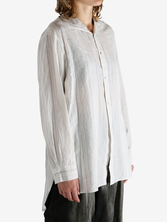 White shirt worn by a person, showing the shirt's fit