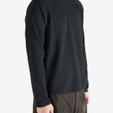 Black shirts worn by a person, showing the shirts fit