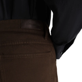 Close up of brown pant, showing texture of the cotton fabric