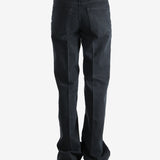 Black pants worn by a person, showing the pants' fit