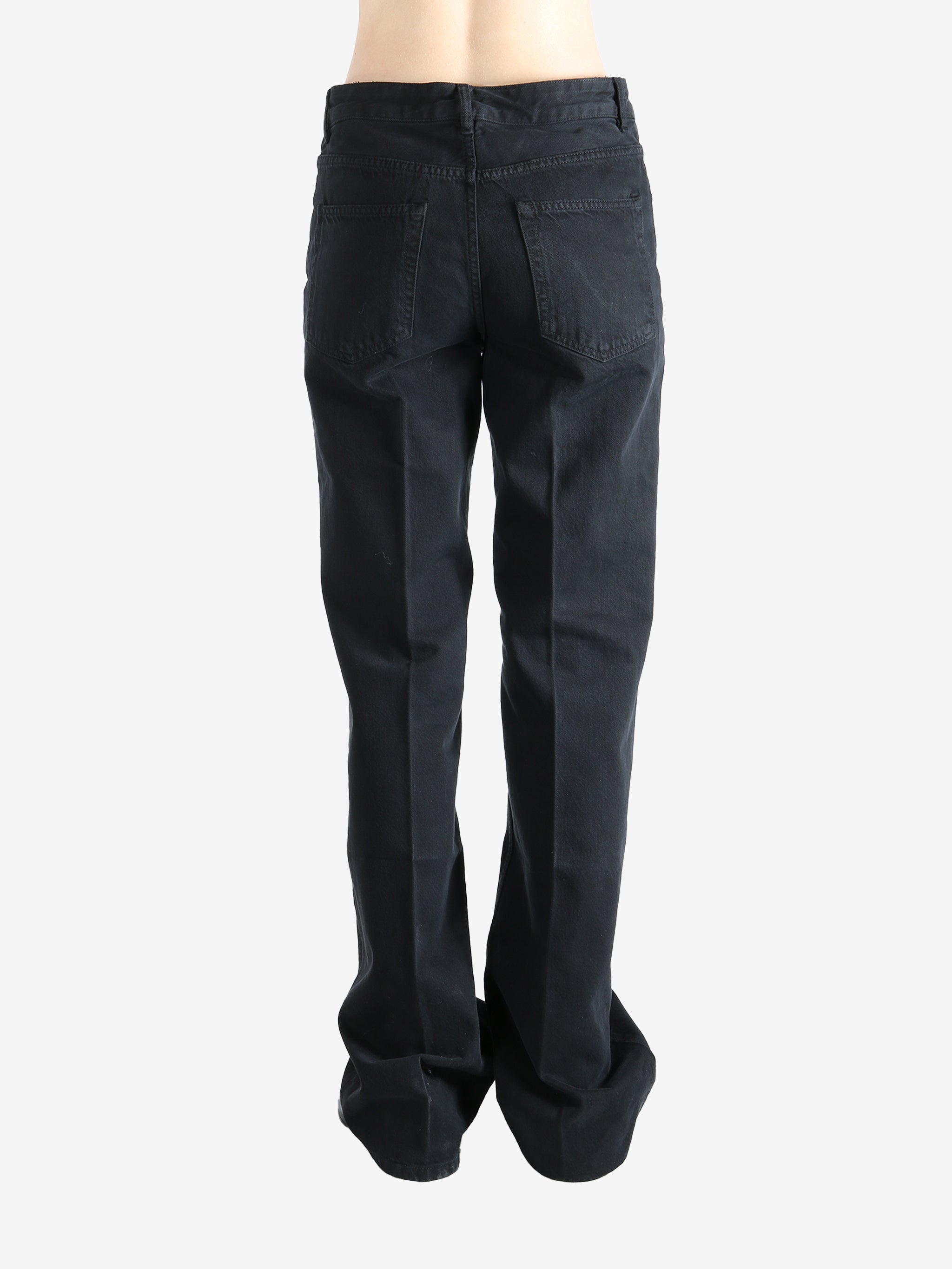 Black pants worn by a person, showing the pants' fit