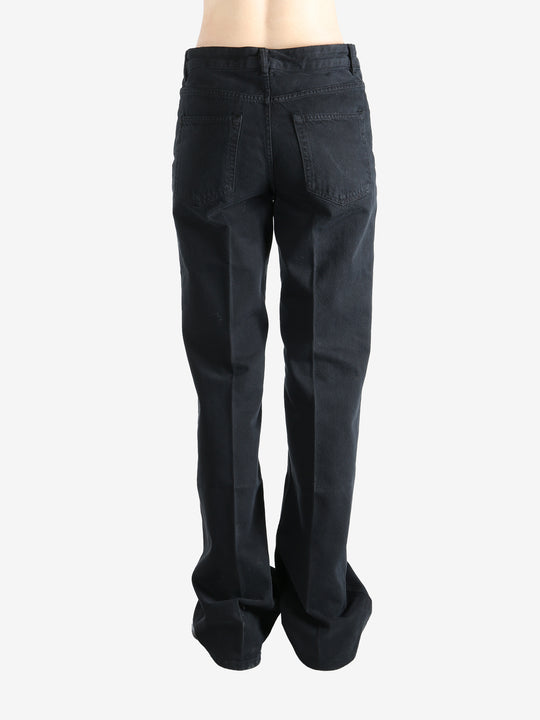 Black pants worn by a person, showing the pants' fit