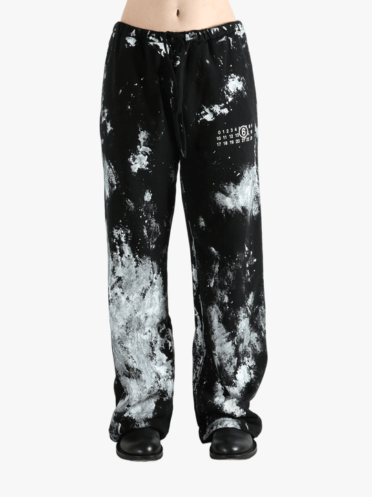Black pants worn by a person, showing the pants' fit
