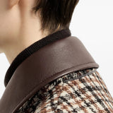 Brown jacket worn by a person, showing the jacket fit