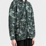 Green jacket worn by a person, showing the jacket fit