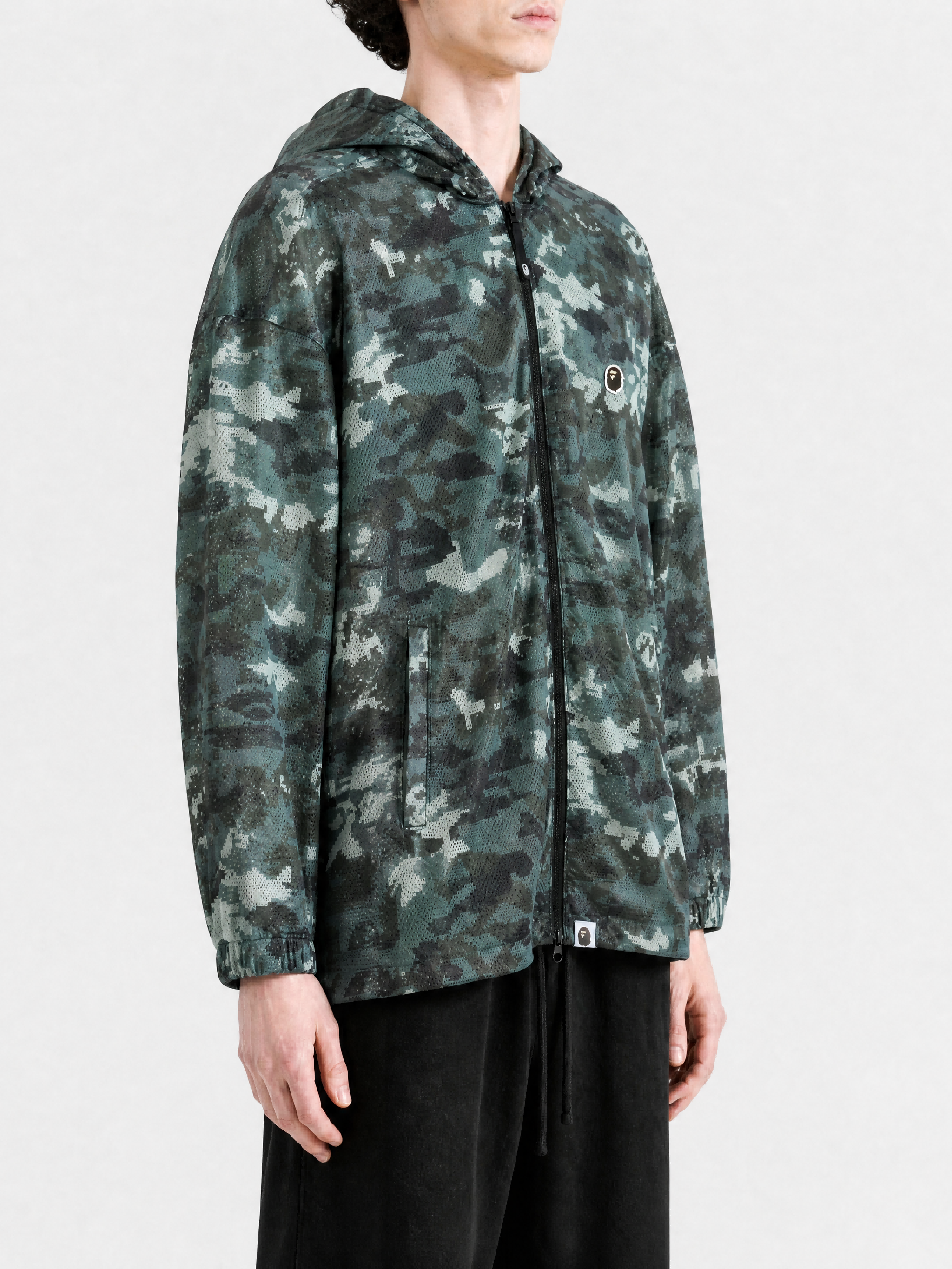 Green jacket worn by a person, showing the jacket fit