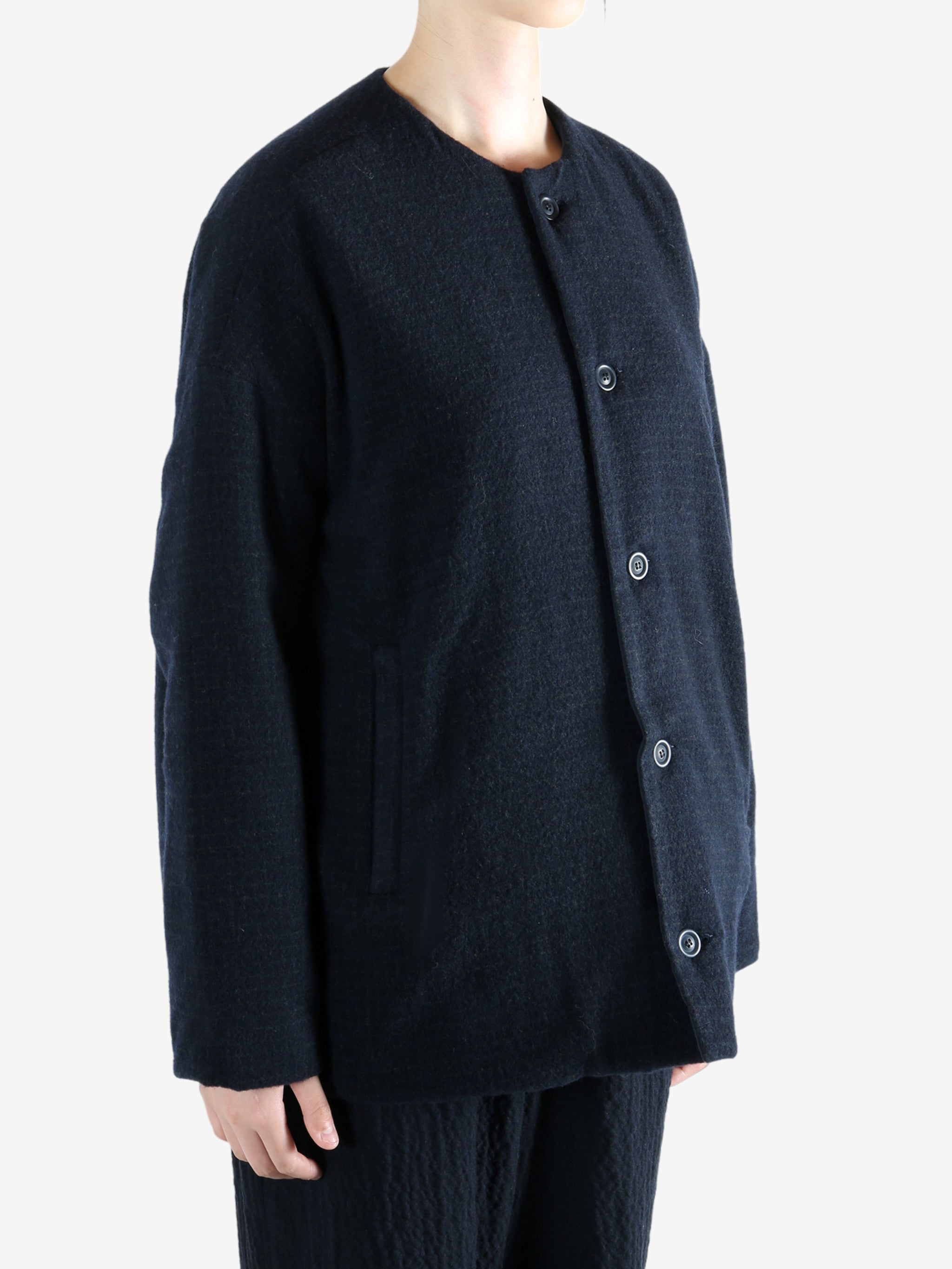 Black jacket worn by a person, showing the jacket fit