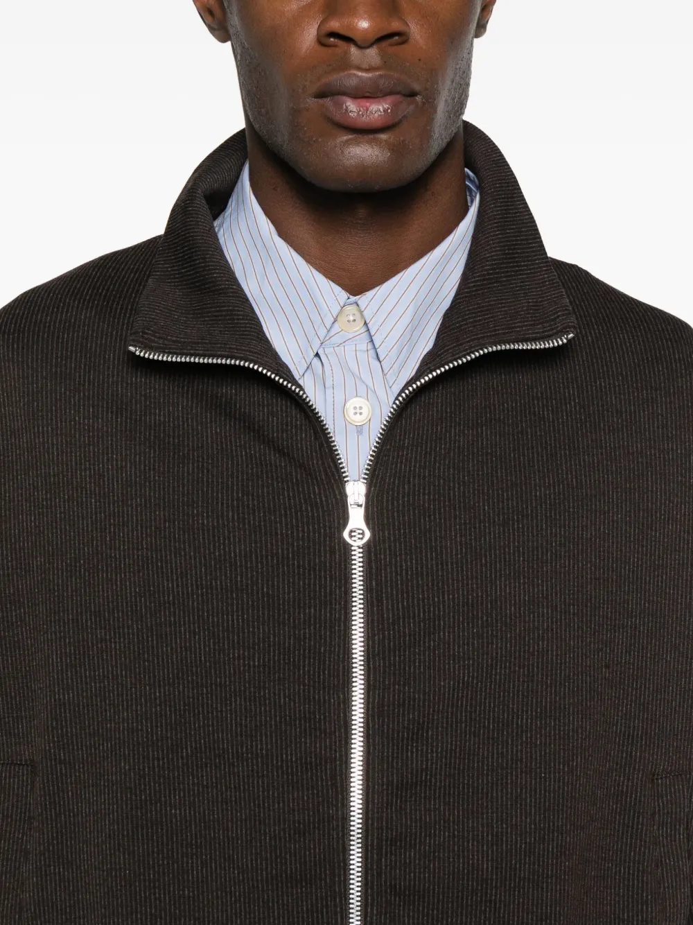 Close up of brown jackets, showing texture of the cotton and polyester and wool and polyamide fabric