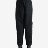 Black pants worn by a person, showing the pants' fit