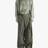 Green pants worn by a person, showing the pants's fit