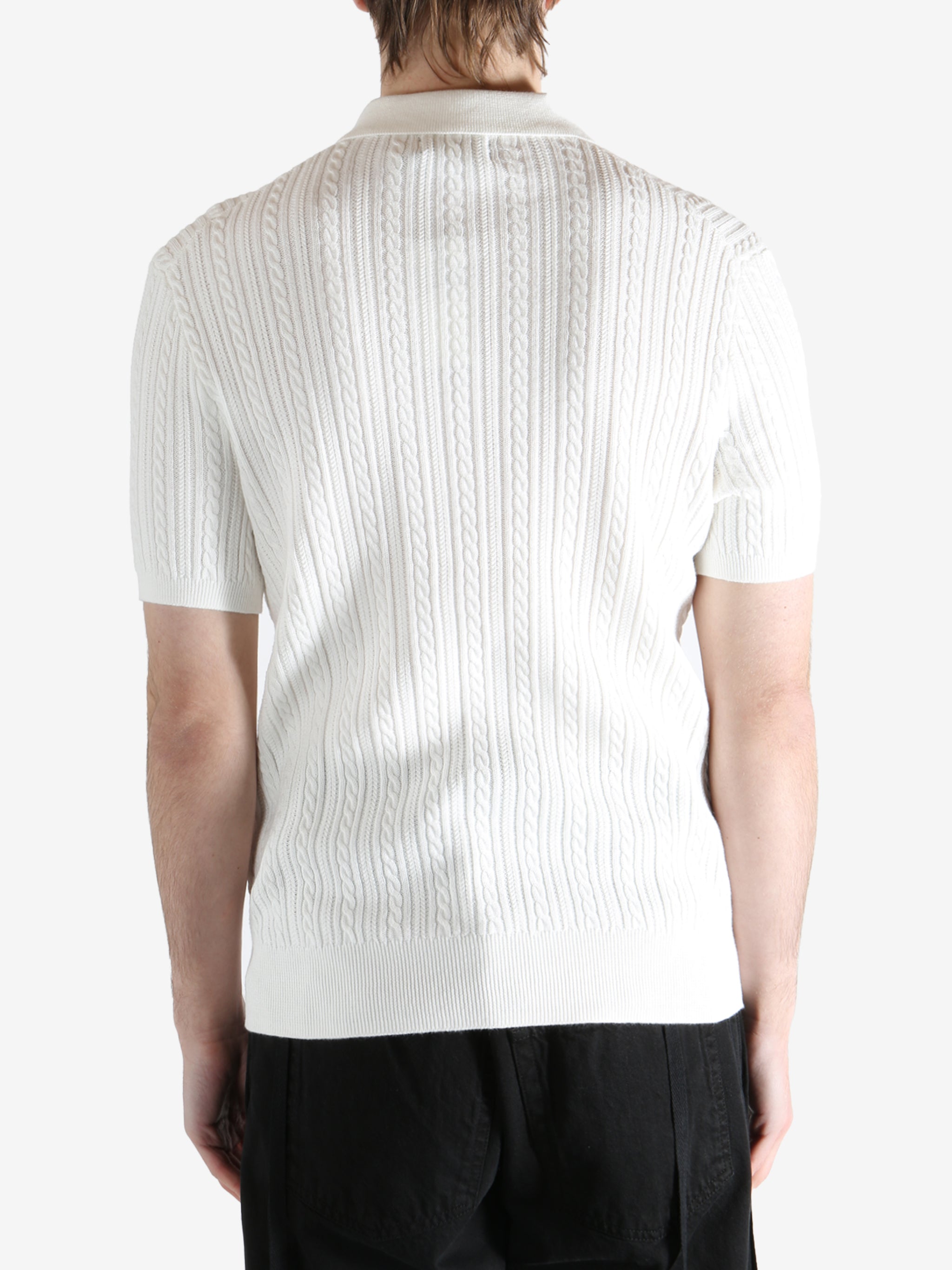 White shirt worn by a person, showing the shirt's fit