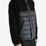 Black jackets worn by a person, showing the jackets fit