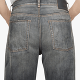 Black jeans worn by a person, showing the jeans fit