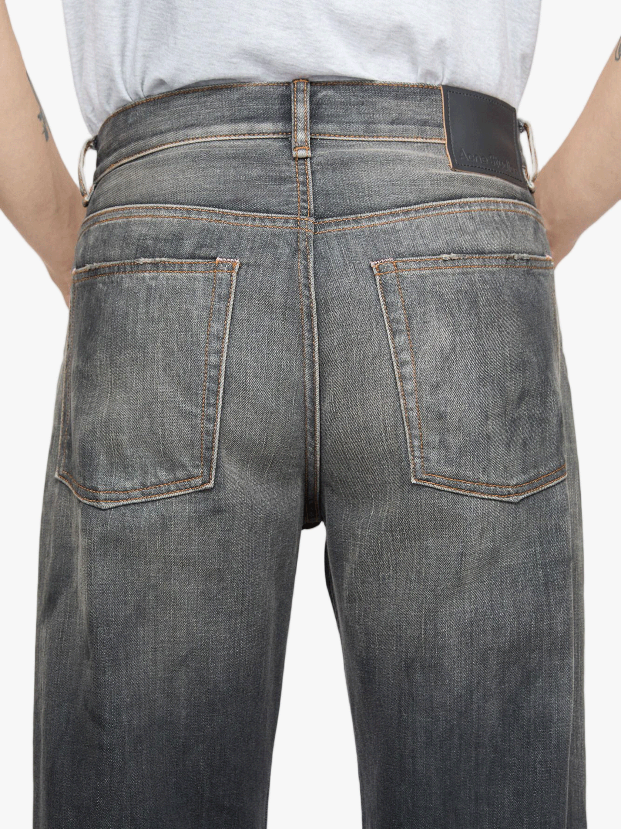 Black jeans worn by a person, showing the jeans fit
