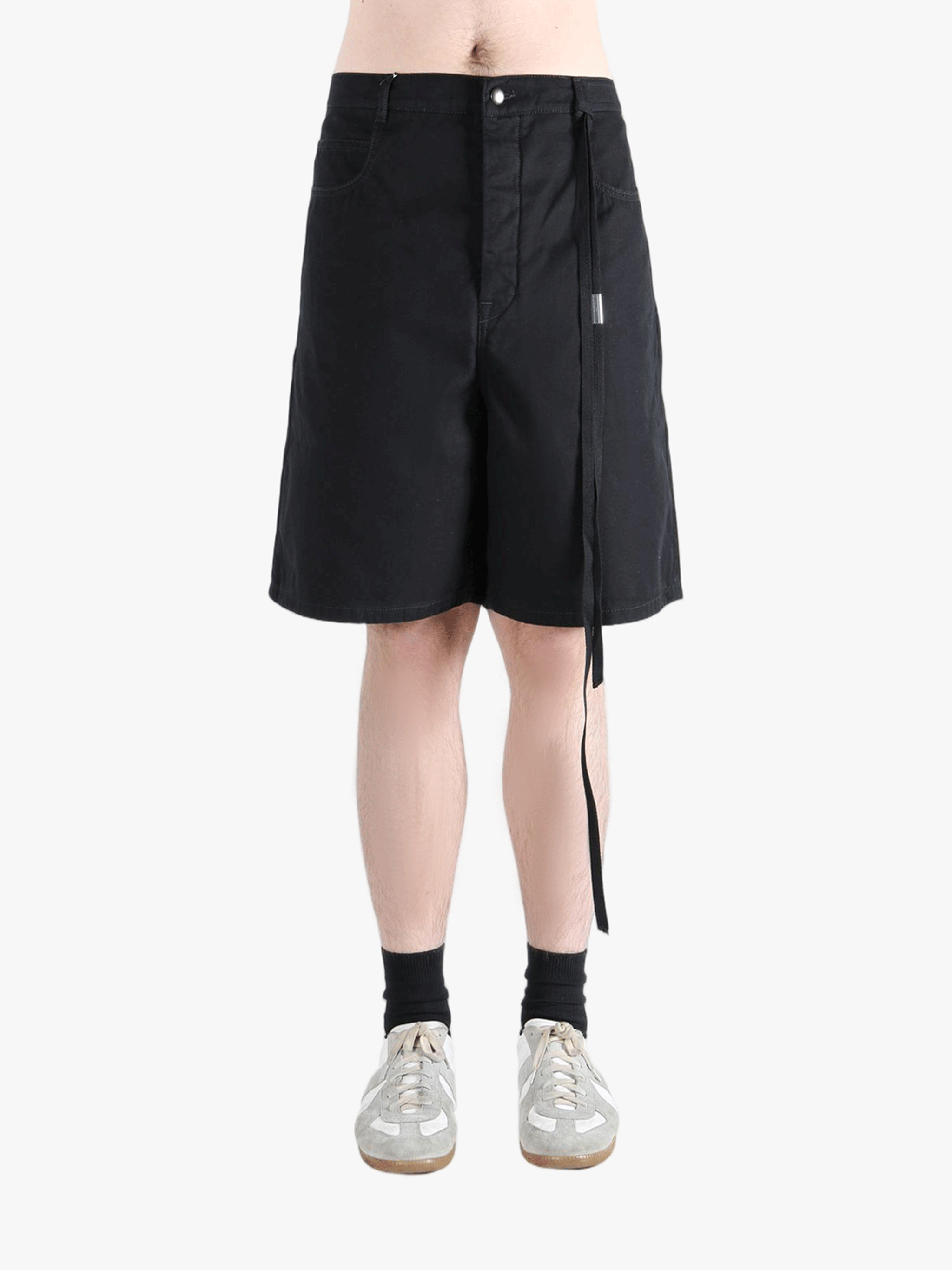 Black short worn by a person, showing the cotton fit