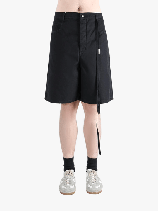 Black short worn by a person, showing the cotton fit