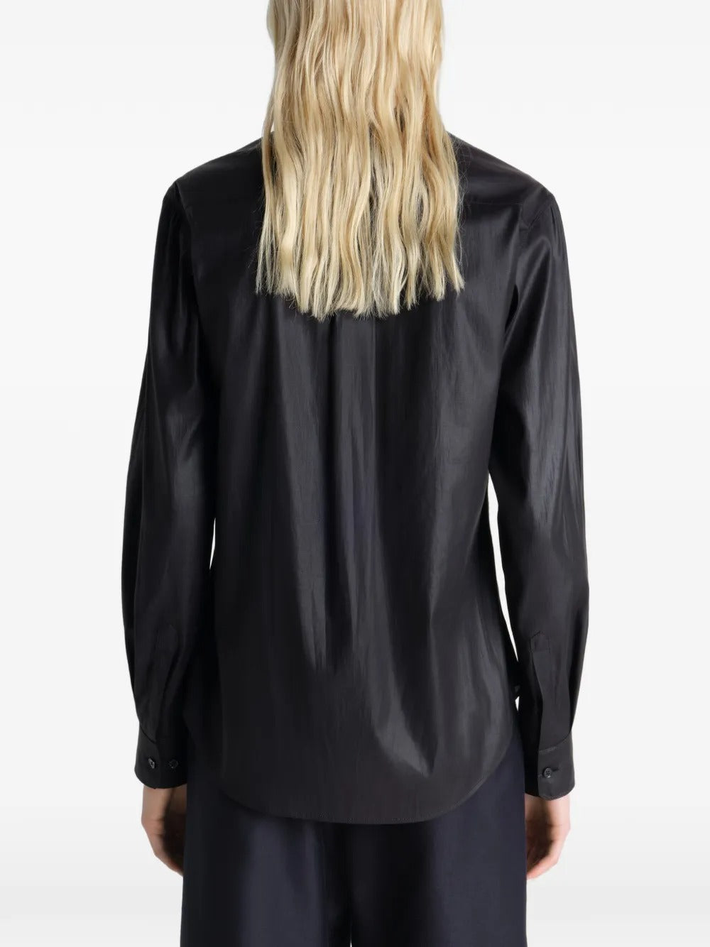 Black shirt worn by a person, showing the shirt's fit