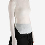 White top worn by a person, showing the top's fit